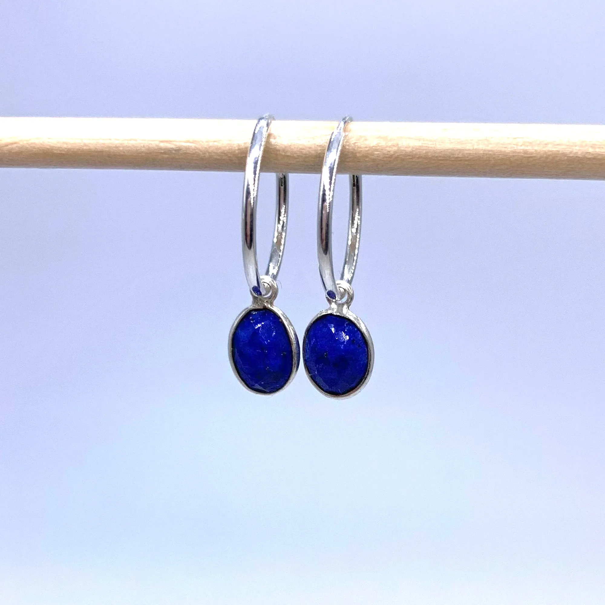Gemstone earrings with lapis lazuli (blue) oval crystal drops on silver small hoops